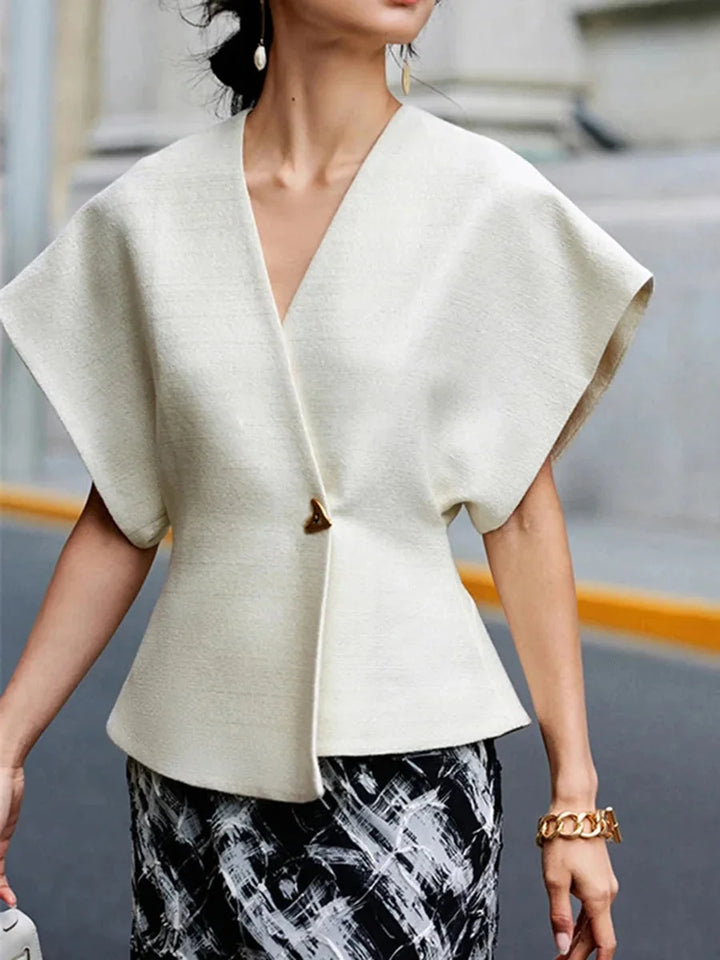 Chic wrap-style blouse in soft crepe fabric with sculpted sleeves in solid color.