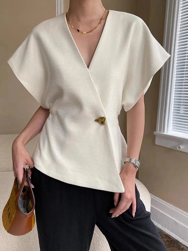 "Black wrap-style blouse with sculpted sleeves, perfect for a chic and stylish look."