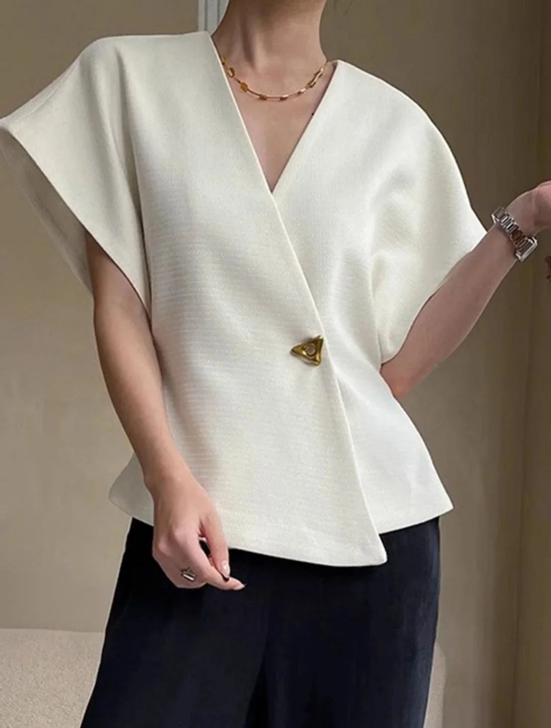 "Jolene blouse in wrap style, sculpted sleeves. Soft fabric and elegant design for chic look."