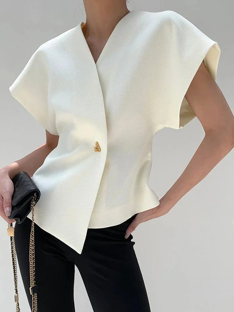 White wrap-style blouse with sculpted sleeves made from soft cotton blend, showcasing chic and modern design.