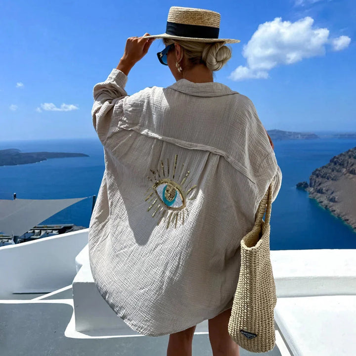 "Women's oversized blouse in breezy fabric with eye motif design, ideal for casual chic looks."