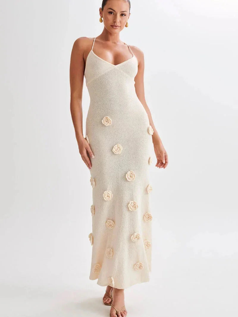 White maxi dress with floral embellishments, perfect for a garden party. Made of flowy, lightweight fabric for a comfortable…