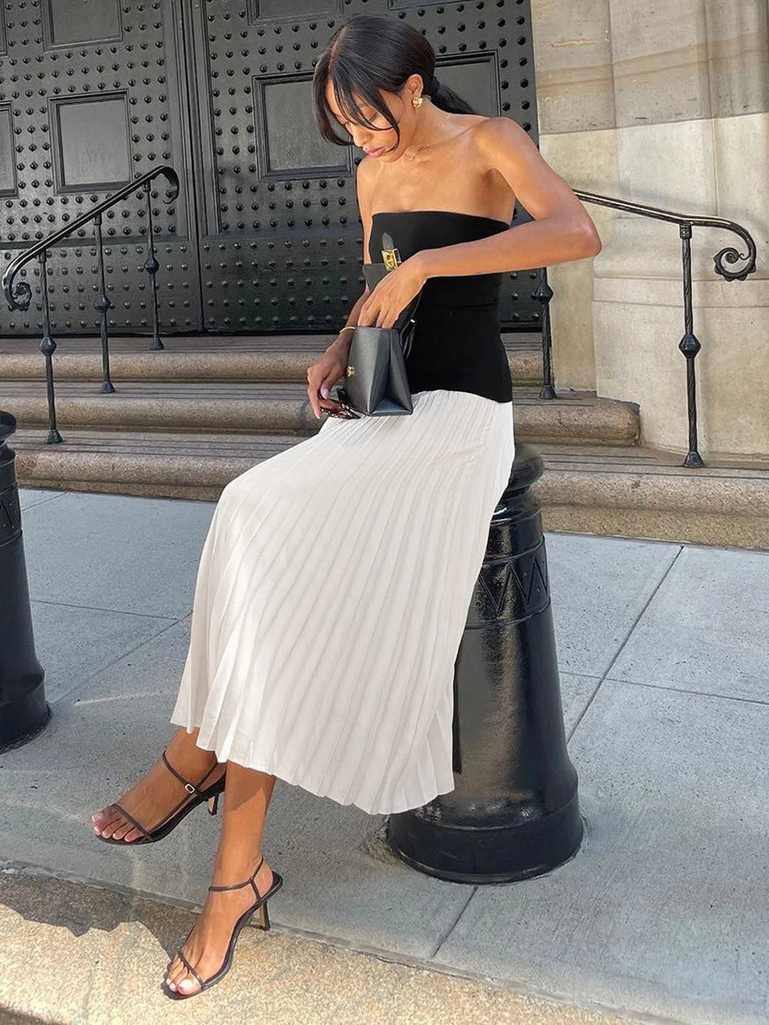Strapless pleated maxi dress with two-tone design in flowy fabric perfect for special occasions or casual events.