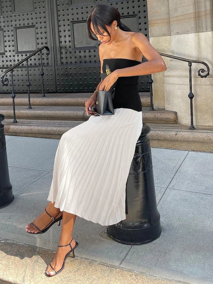 Strapless pleated maxi dress with two-tone design in flowy fabric perfect for special occasions or casual events.