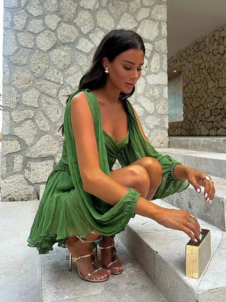Green dress with puff sleeves and ruffled hem, made from soft cotton blend. Stylish and feminine, perfect for any casual…