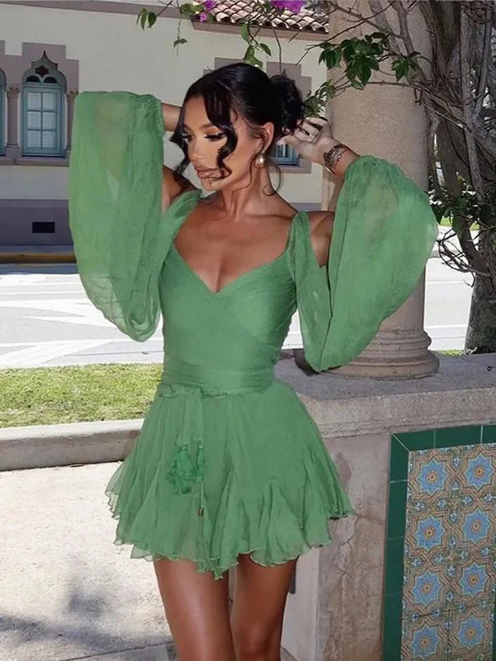 "Green dress with puff sleeves and ruffled hem, made of lightweight fabric, perfect for casual outings or events."