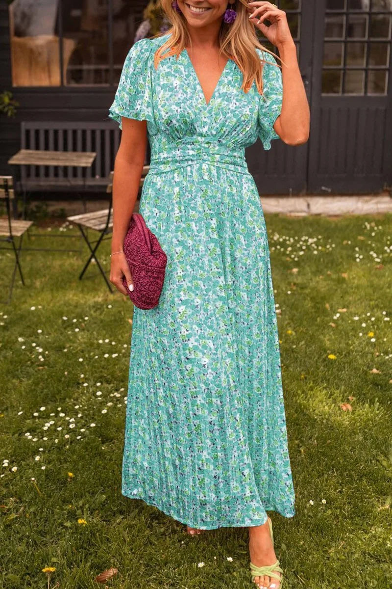 Green floral maxi dress with V-neck and flowy skirt, perfect for summer. Made of high-quality cotton blend material.