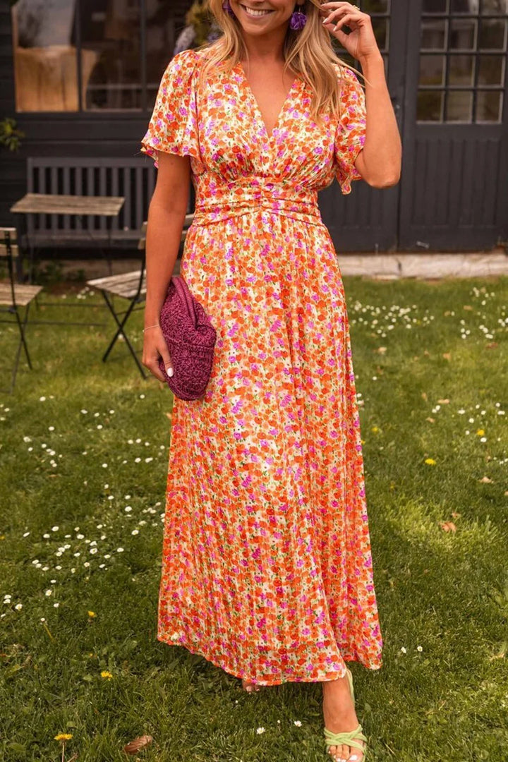 "Orange floral maxi dress for women made with lightweight chiffon fabric, featuring a flowy silhouette and vibrant print."