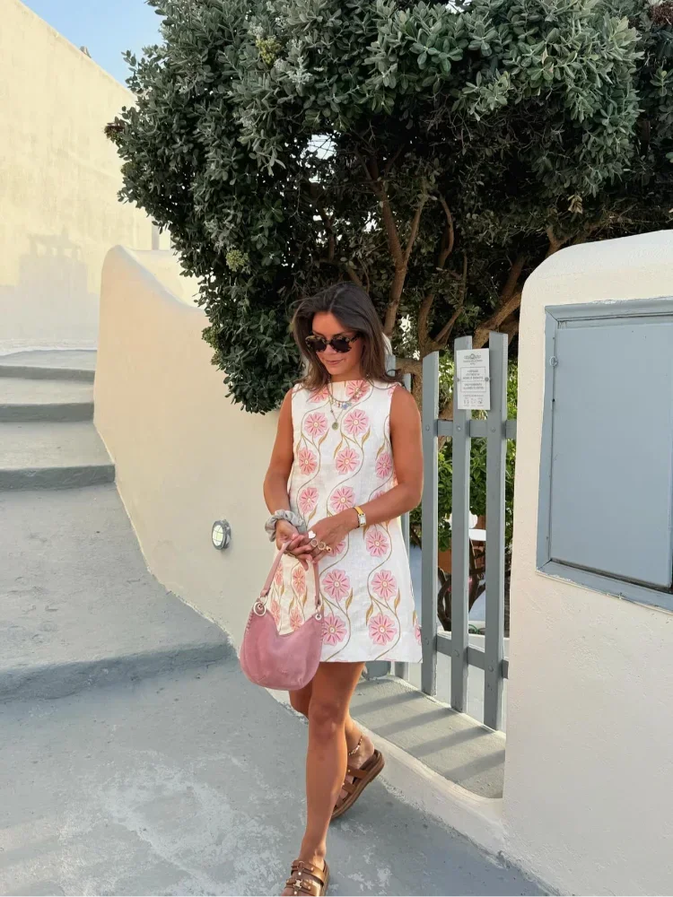 Pink floral A-line sleeveless dress made of soft cotton blend. Features a dainty floral pattern, perfect for a casual summer…