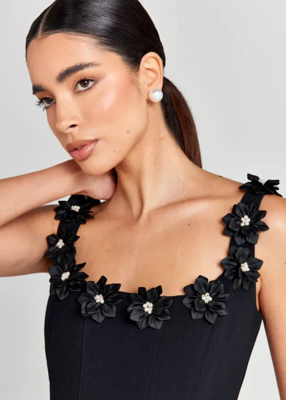 Black mini dress with elegant white floral embroidery design, perfect for a stylish and sophisticated look.