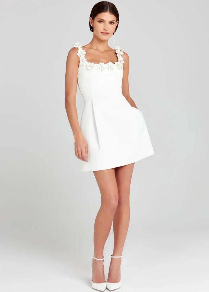 Black mini dress with white floral embroidery on the front, crafted in soft and stretchy fabric. Perfect for a chic and…