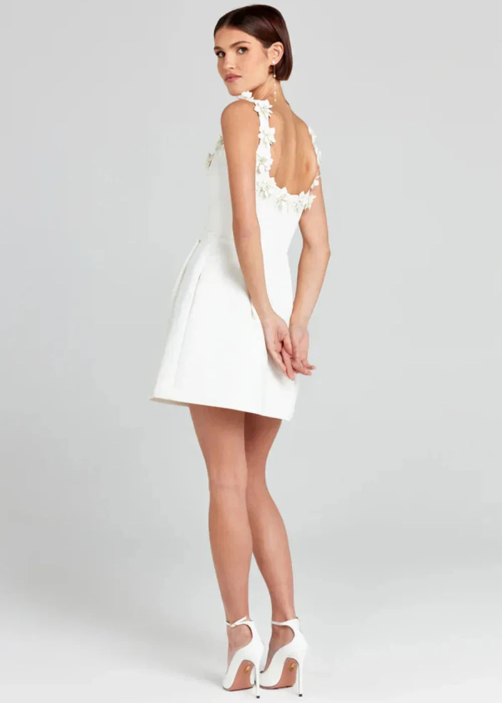 Black mini dress with white floral embroidery on the bodice, made of lightweight cotton blend fabric with a flattering fit.