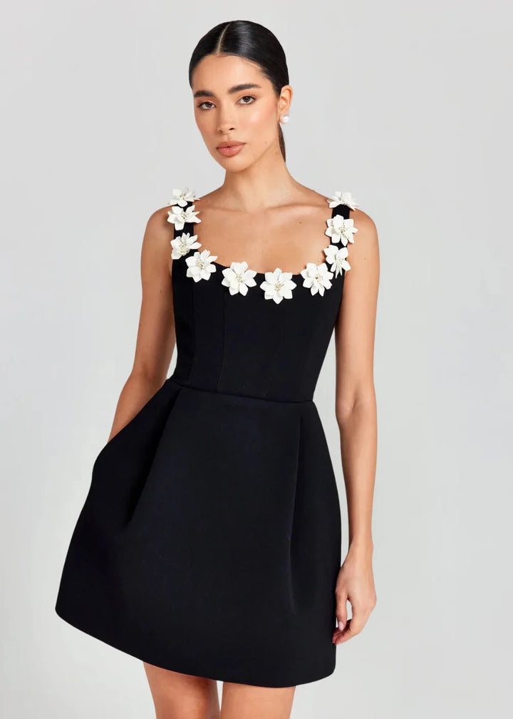 Black mini dress with white floral embroidery, made from smooth cotton blend. Perfect for casual outings or special…