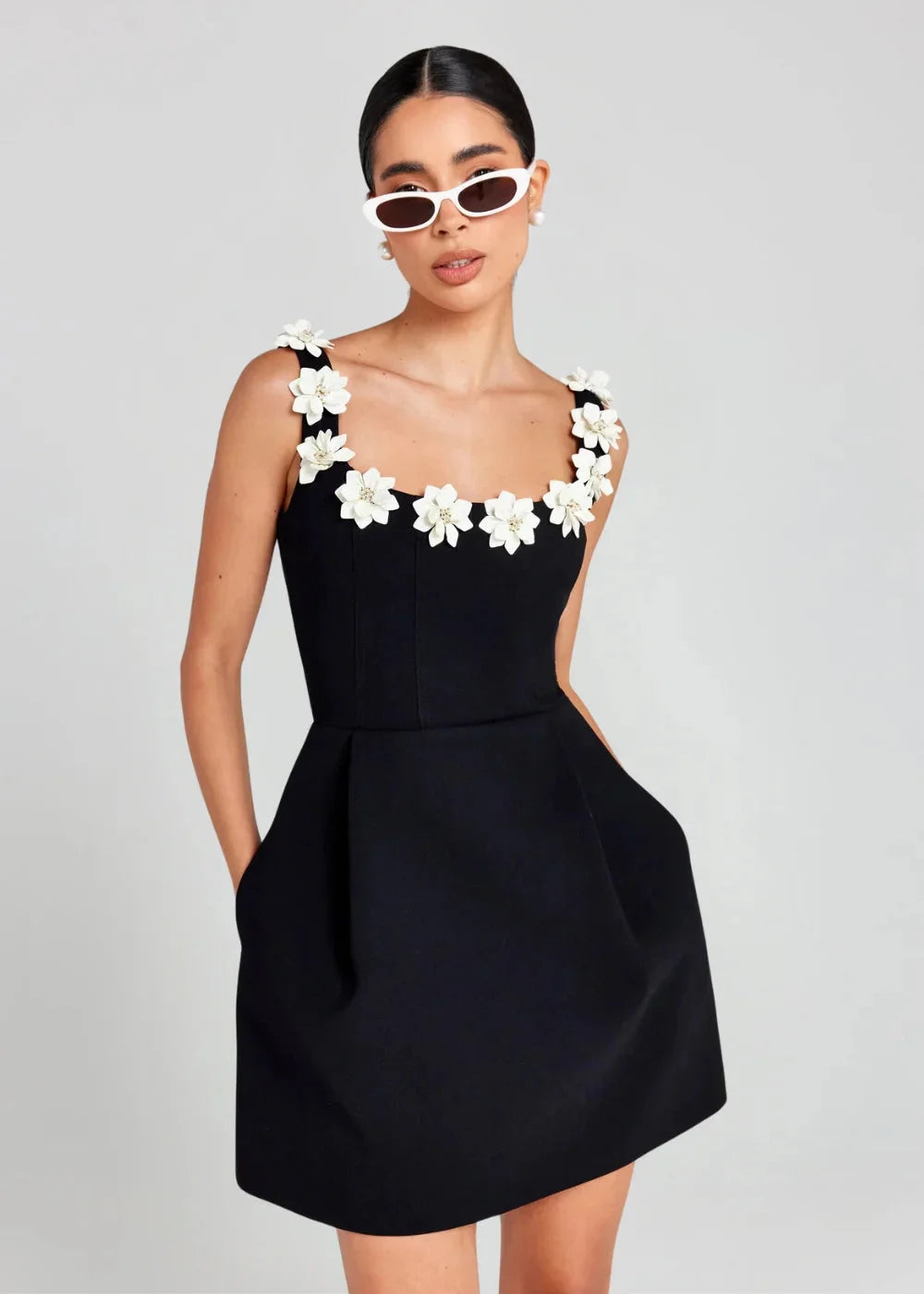 Black mini dress with white floral embroidery, perfect for a chic and elegant look. Made of high-quality fabric with…