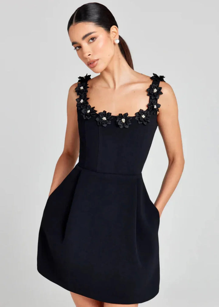 "Black mini dress featuring white floral embroidery on lightweight fabric - Kaileen collection"