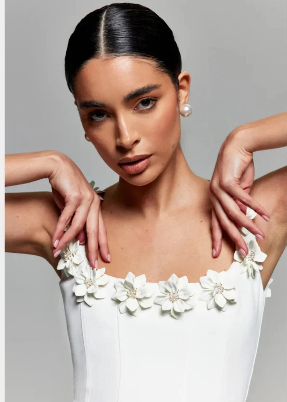 "Black mini dress featuring white floral embroidery, perfect for a chic and elegant look. Made from high-quality materials."