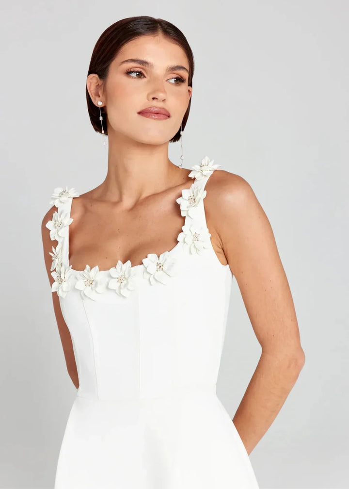 Black mini dress with white floral embroidery, made of lightweight fabric. Perfect for effortless chic outfits.