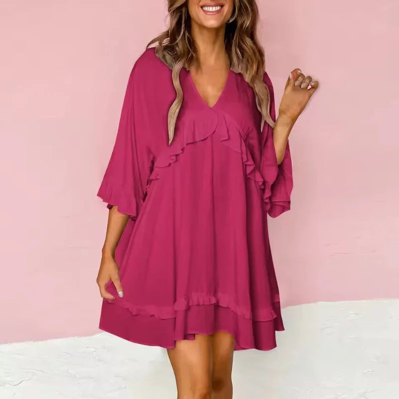 Hot pink V-neck dress with flared silhouette and ruffle accents. Made from lightweight, flowy fabric perfect for a stylish…