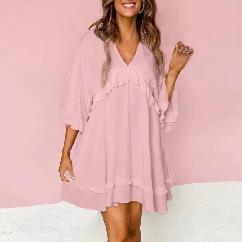 Light pink flared V-neck dress with charming ruffle details. Soft and airy fabric for a chic and feminine look.