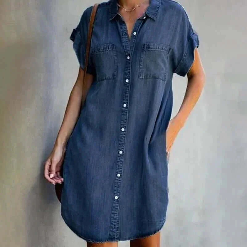 Dark blue denim dress with button-front and pockets. Casual and practical for everyday wear.