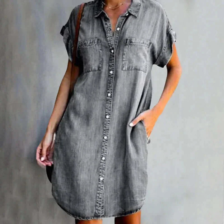 Gray denim dress with pockets, button-front design. Casual and stylish, perfect for everyday wear.