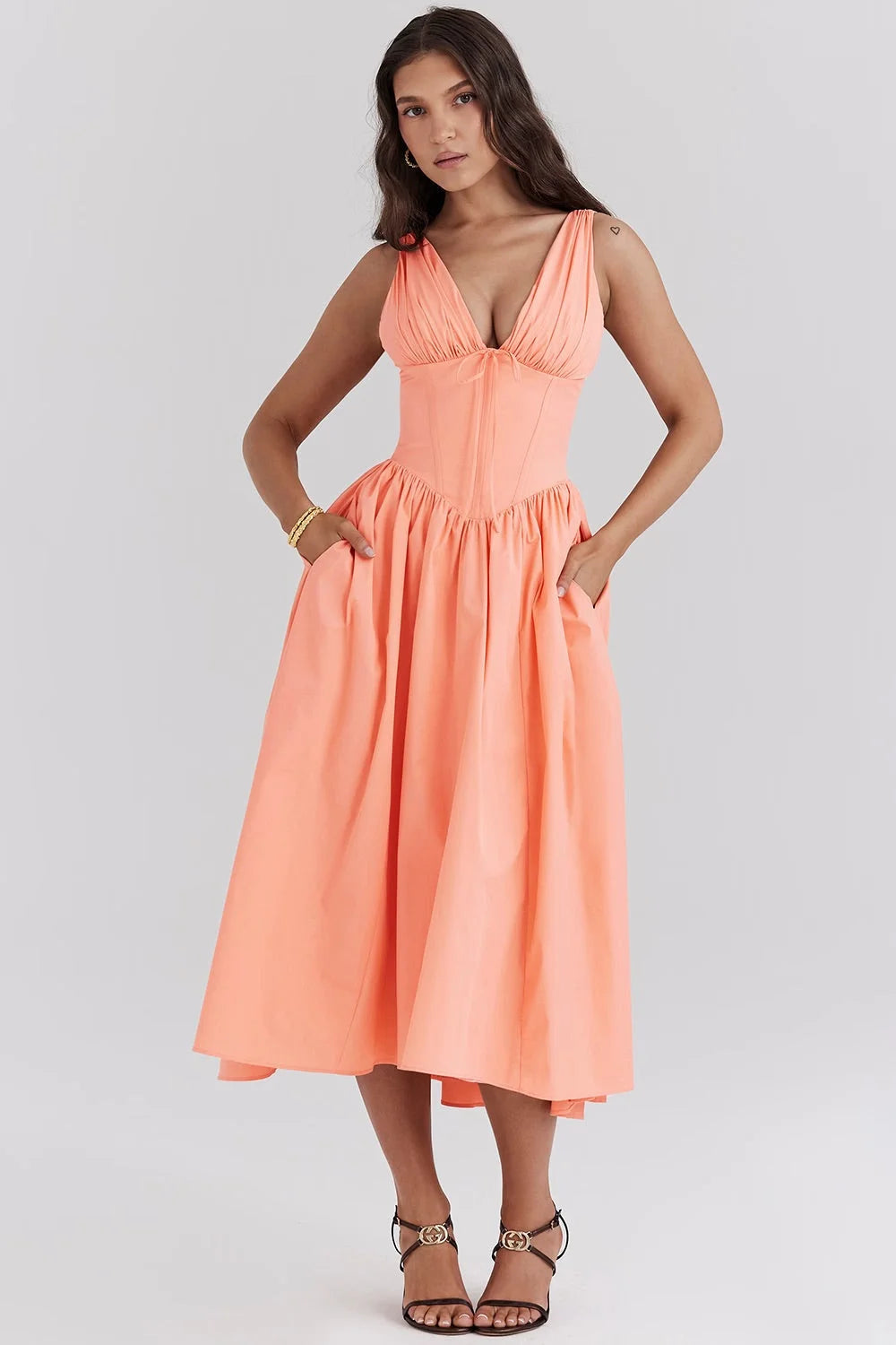 Peach floral midi dress with v-neckline showcasing a lightweight and soft fabric perfect for a stylish and feminine look.