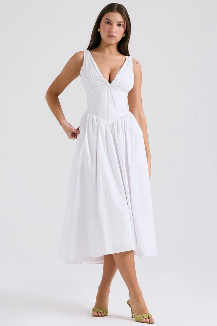 White floral midi dress with v-neckline made from lightweight cotton blend. Perfect for a casual day out or a summer…
