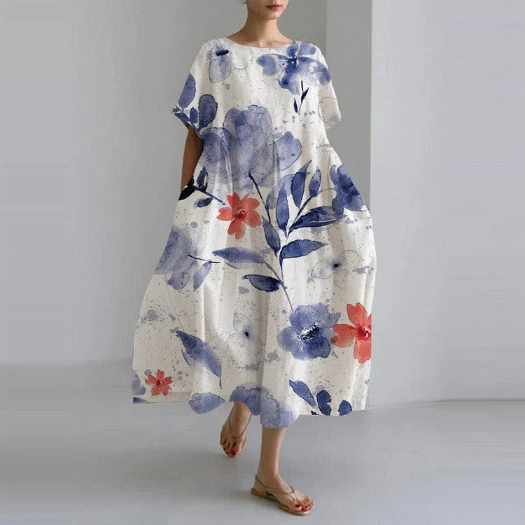 "Kami relaxed-fit dress in Watercolour Flowers with delicate floral pattern, flowing silhouette, and soft fabric."