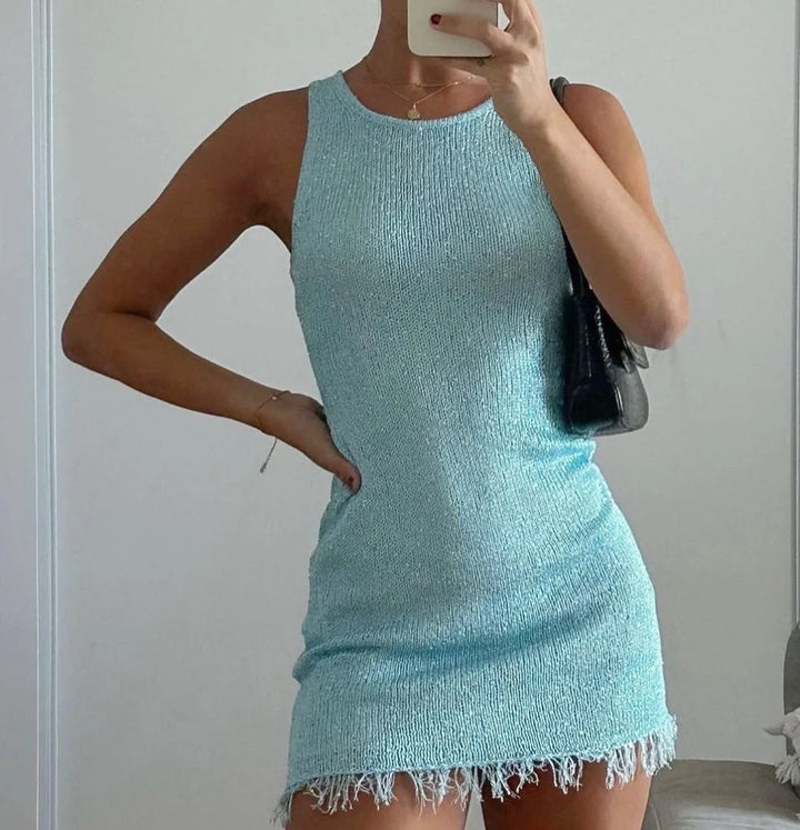Sleeveless mini dress with sparkly finish, perfect for parties or events.
