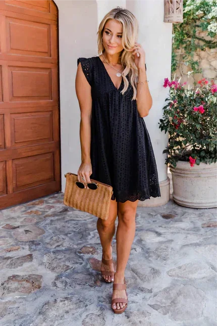 Sleeveless black lace dress with side pockets, perfect for any occasion.