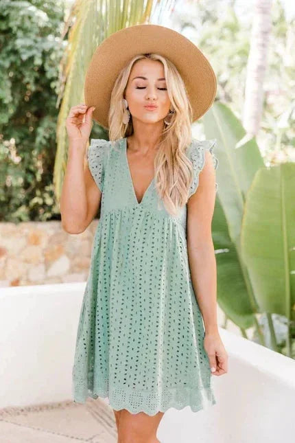 Light green sleeveless lace dress with side pockets by Kamorah. Delicate lace detailing and convenient pockets for a…