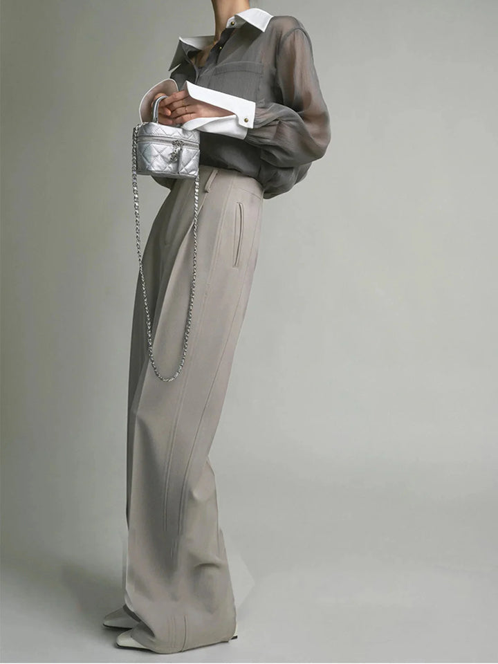 Sheer white button-up blouse with chic collar, perfect for a casual yet sophisticated look.
