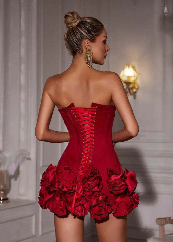 Strapless red dress with elegant rosette detail, perfect for a special occasion.