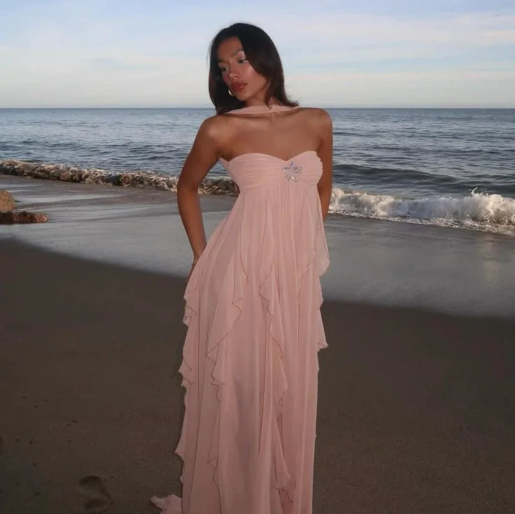 Strapless dress in navy blue with cascading ruffles, ideal for formal occasions.