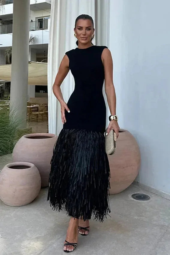 Sleek black dress with fringe detail made from high-quality fabric, perfect for adding a touch of sophistication to your…