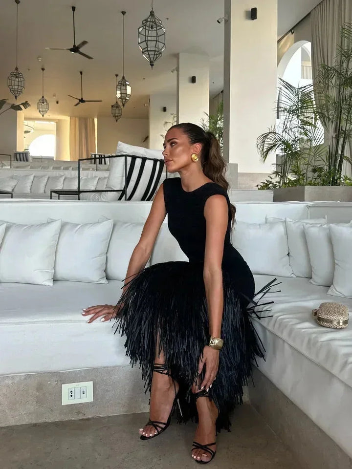 "Black dress with fringe detail, perfect for adding a touch of elegance to your look."