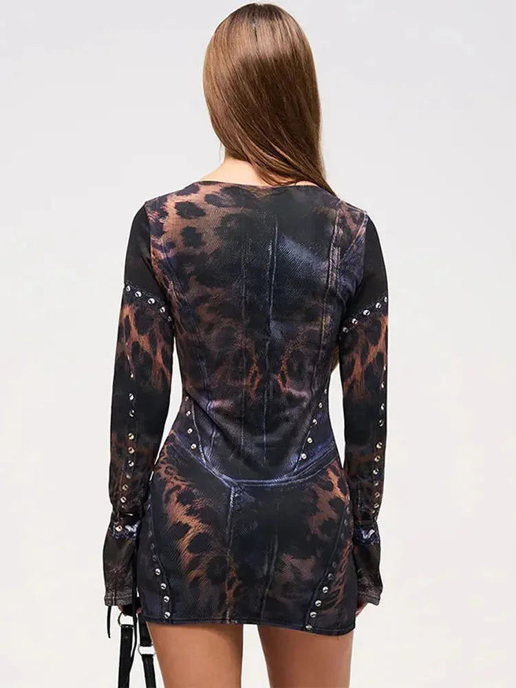 Black abstract print mini dress with studs on sleeves. Made of soft, stretchy fabric, perfect for a trendy and edgy look.