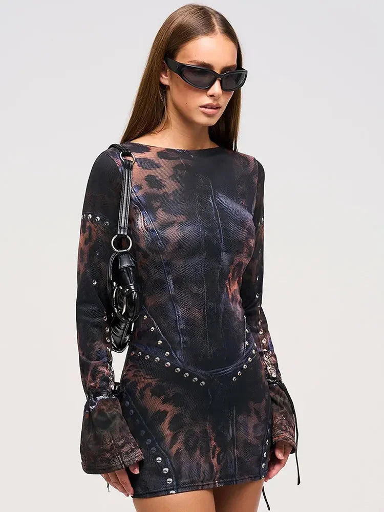 "Black mini dress with abstract print and studs, perfect for a standout look at any event."