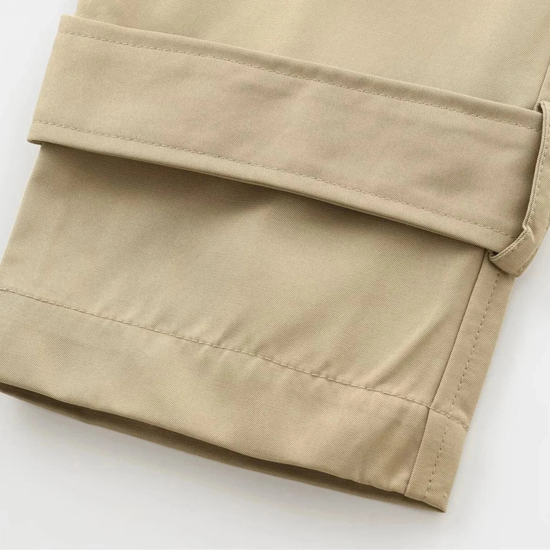 "Beige cropped trenchcoat with button details, chic and stylish design, perfect for autumn layering"