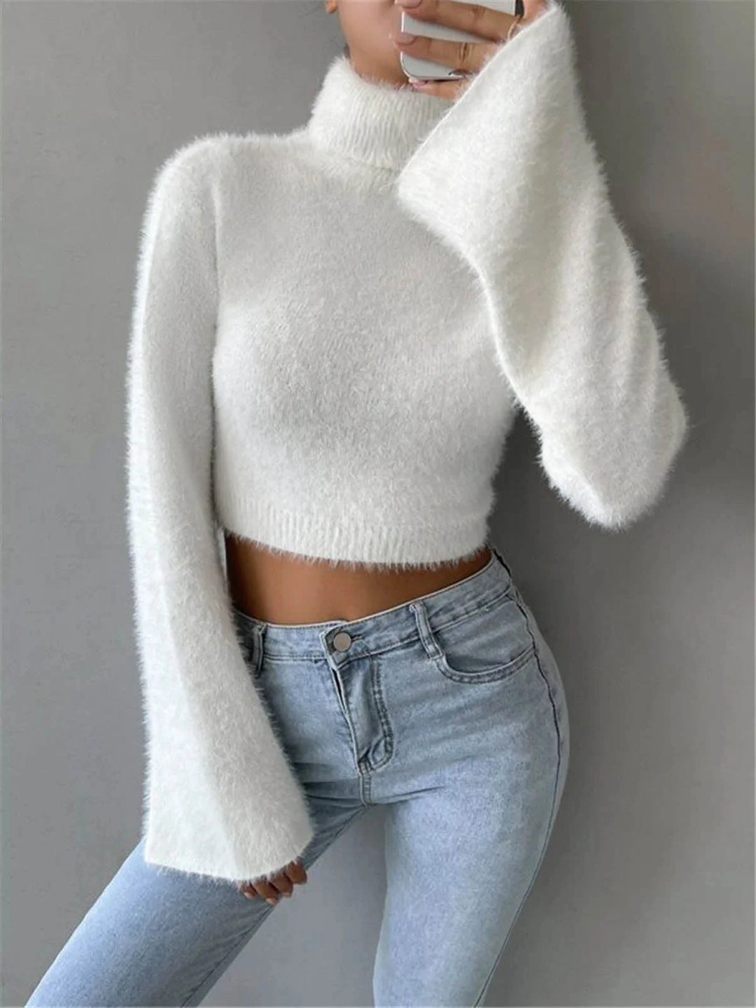 White cropped turtleneck sweater made of soft fluffy material by Keari. Perfect for cozy and stylish winter outfits.