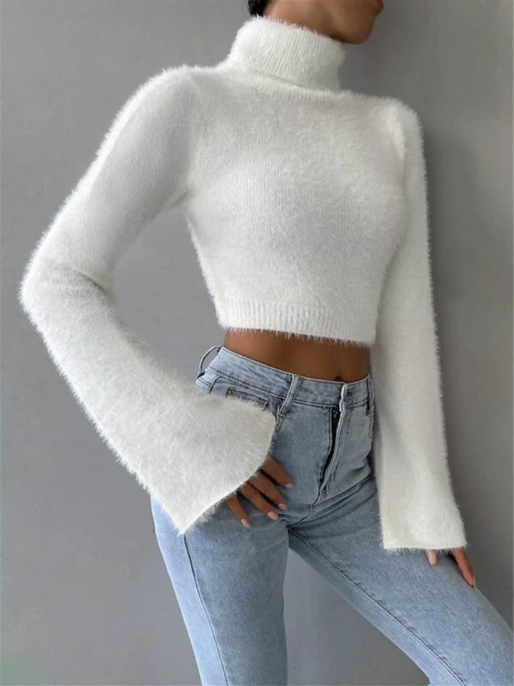 Fluffy white cropped turtleneck sweater made of soft knit material, perfect for cozy and stylish winter outfits.