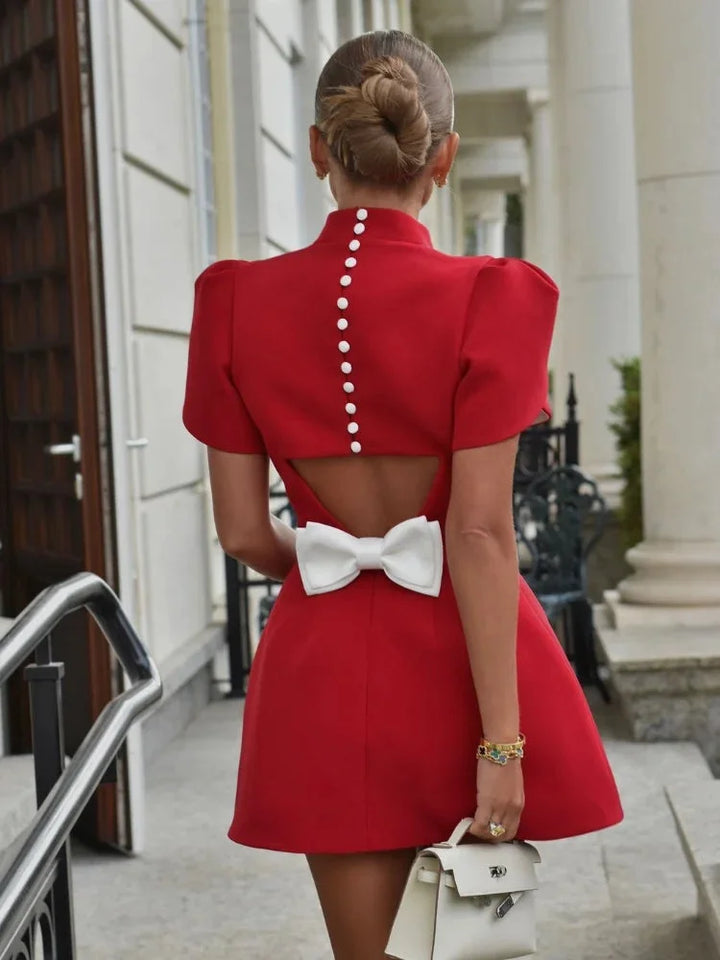 Red mini dress with white button details made with high-quality cotton blend. Perfect for a casual yet stylish look.