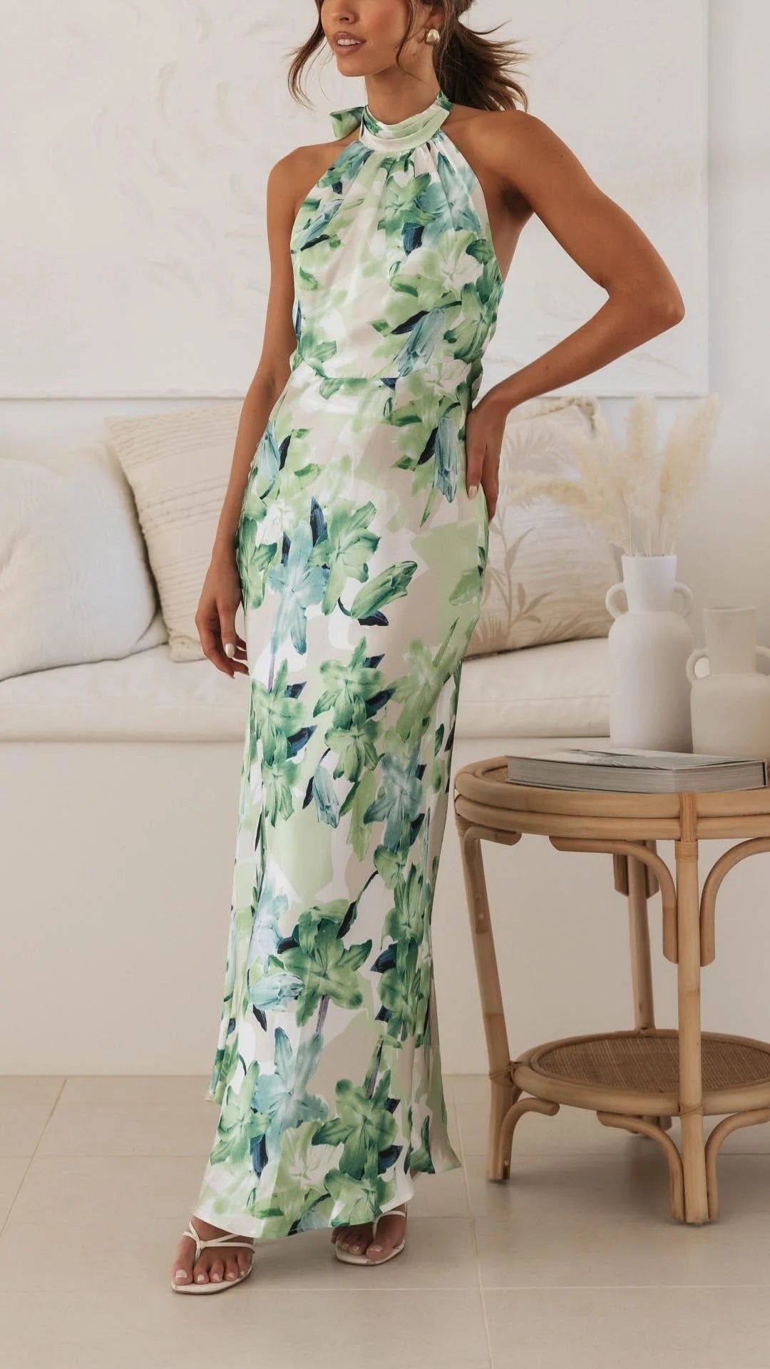 "Floral patterned halter maxi dress with a flowy silhouette, perfect for a casual summer day out. Made with lightweight and…