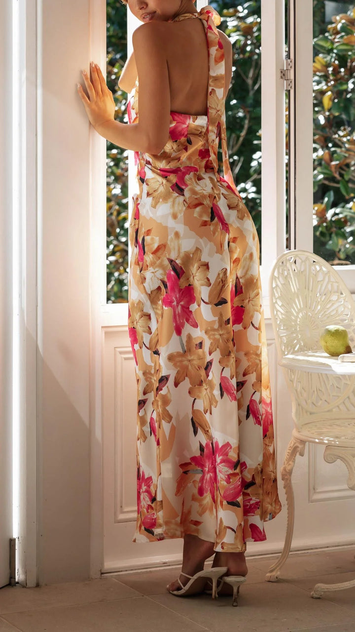 Floral patterned halter maxi dress with a flowy silhouette, perfect for sunny days. Made of lightweight and breathable…
