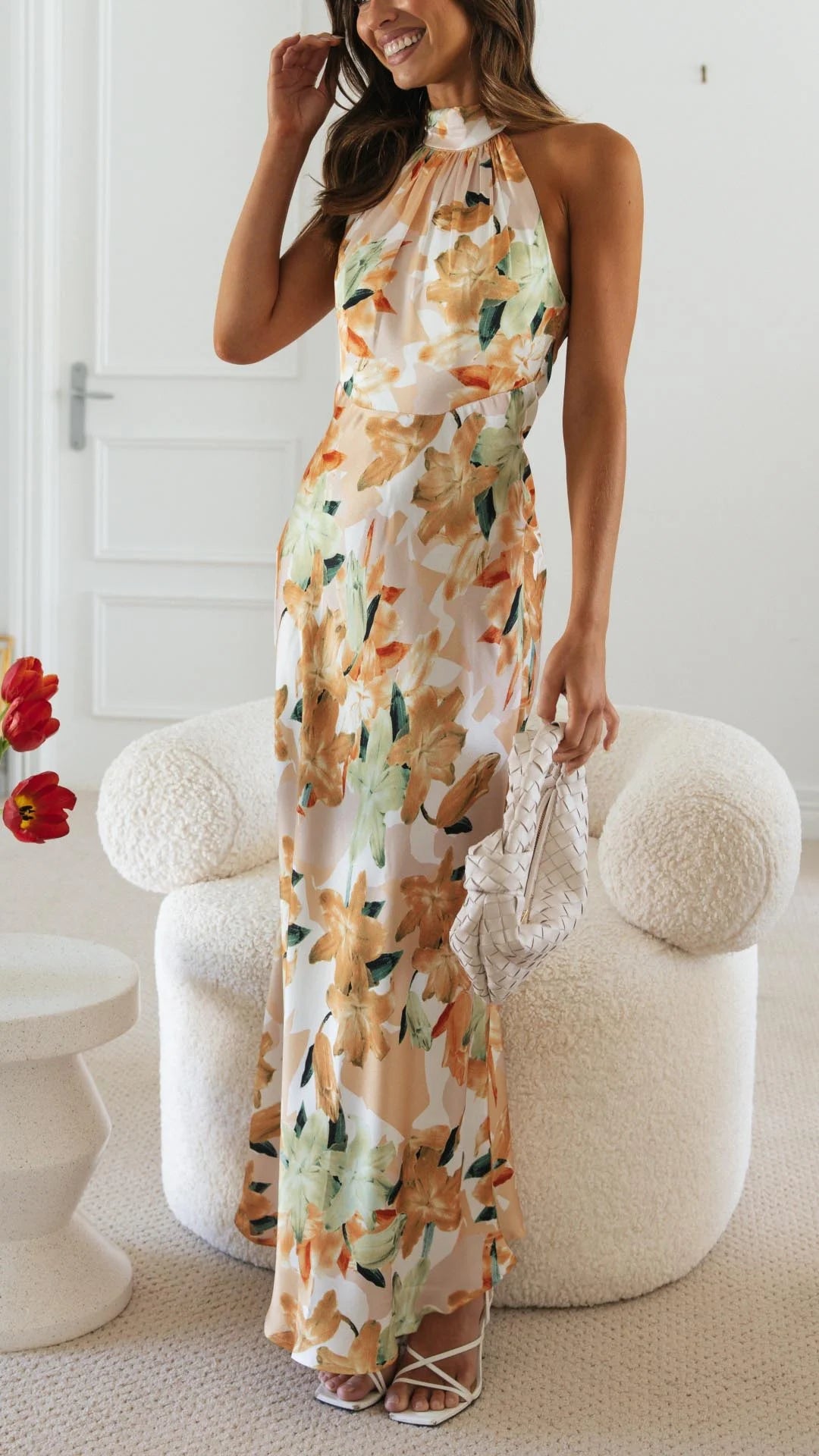 Floral patterned halter maxi dress in vibrant colors with a flowy design perfect for summer; made of lightweight, breathable…