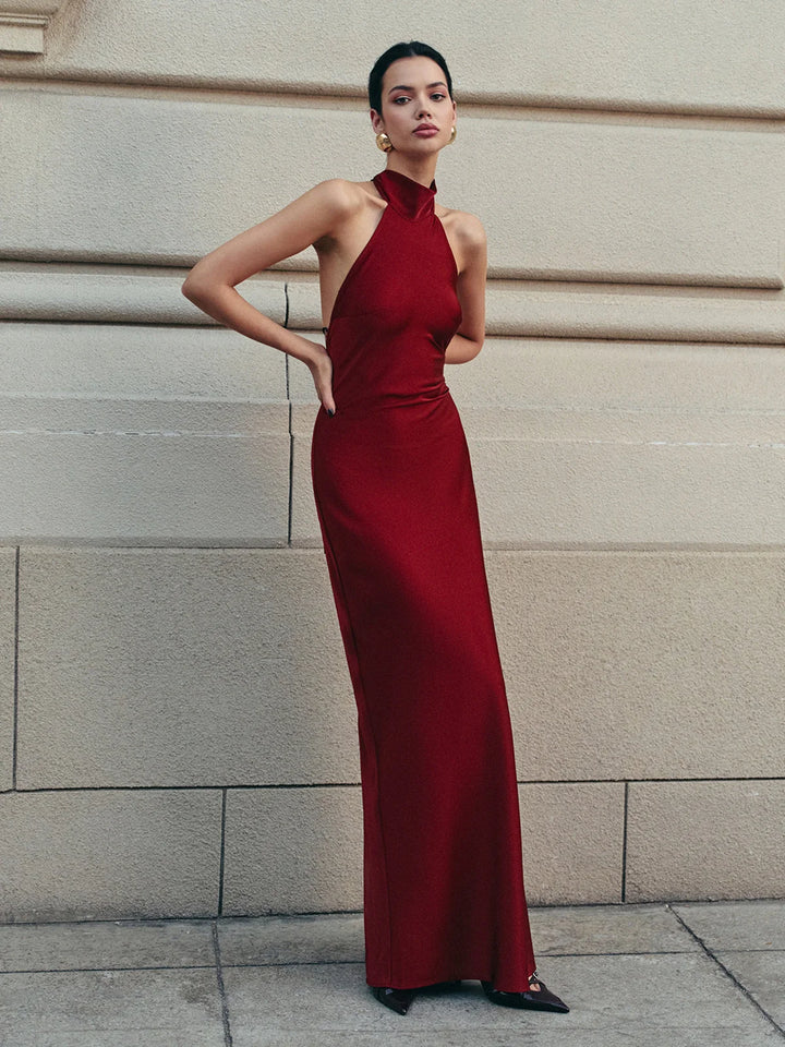 Red satin halter dress with trailing bow, perfect for special occasions.