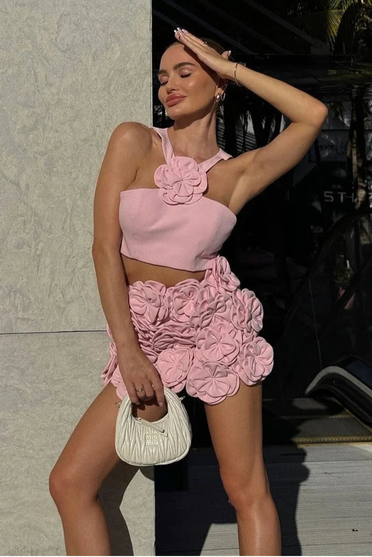 Pink halter top and shorts set with floral applique detailing. Perfect for warm weather, made of soft and breathable fabric…