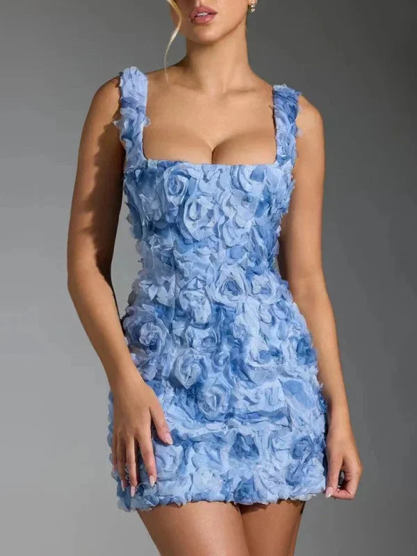 Blue mini dress with floral textured design and straps, perfect for a casual yet stylish look.