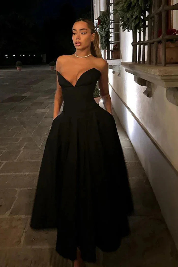 Black strapless corseted A-line midi dress by Kirra, made of satin fabric with lace-up detailing.