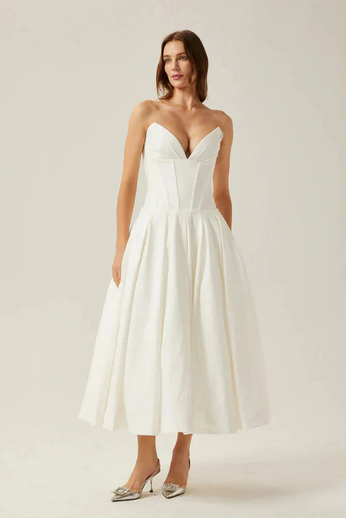 "Kirra Strapless Corseted A-line Midi Dress in ivory satin fabric with lace detailing and elegant silhouette."